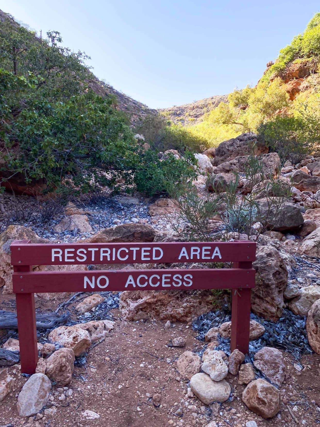 Wooden sign saying restricted access