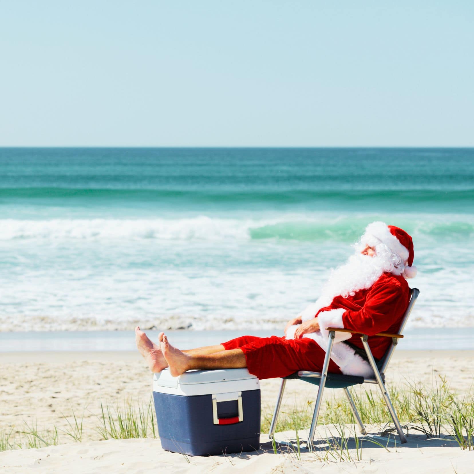 Christmas in Australia Santa on beach with feet up on an eskie