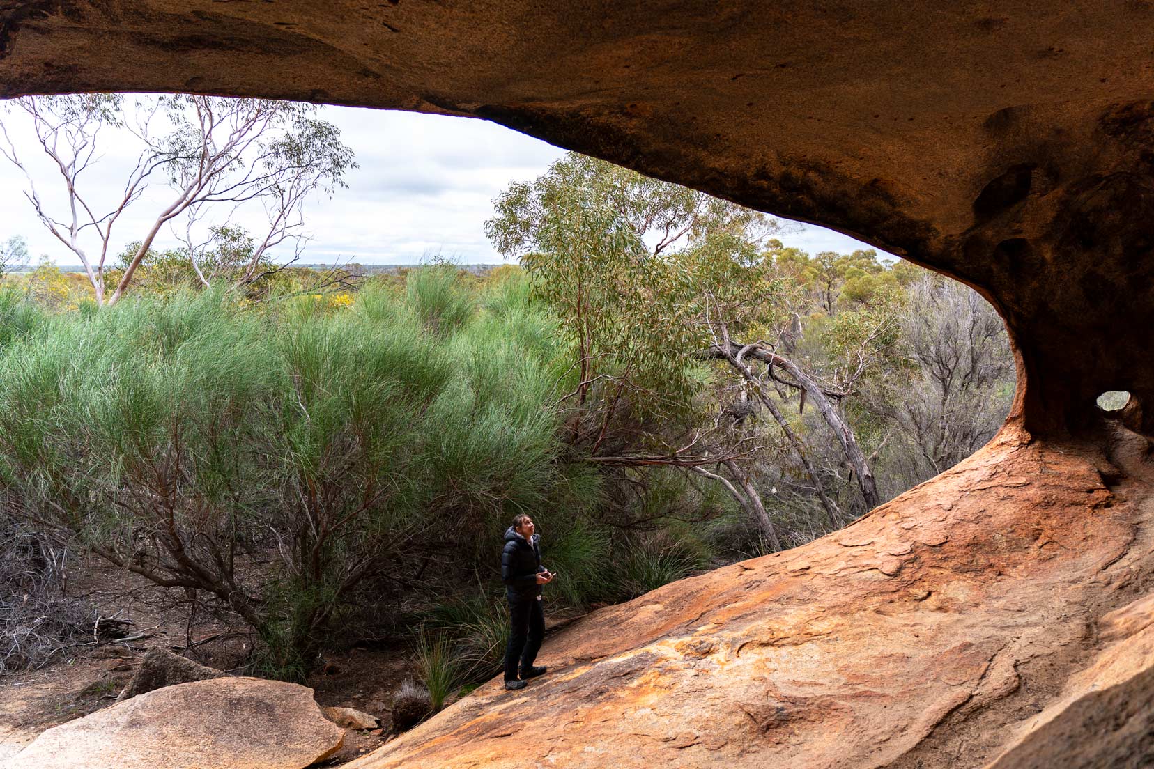 Elachbutting-Rock shelley stood by the cave 